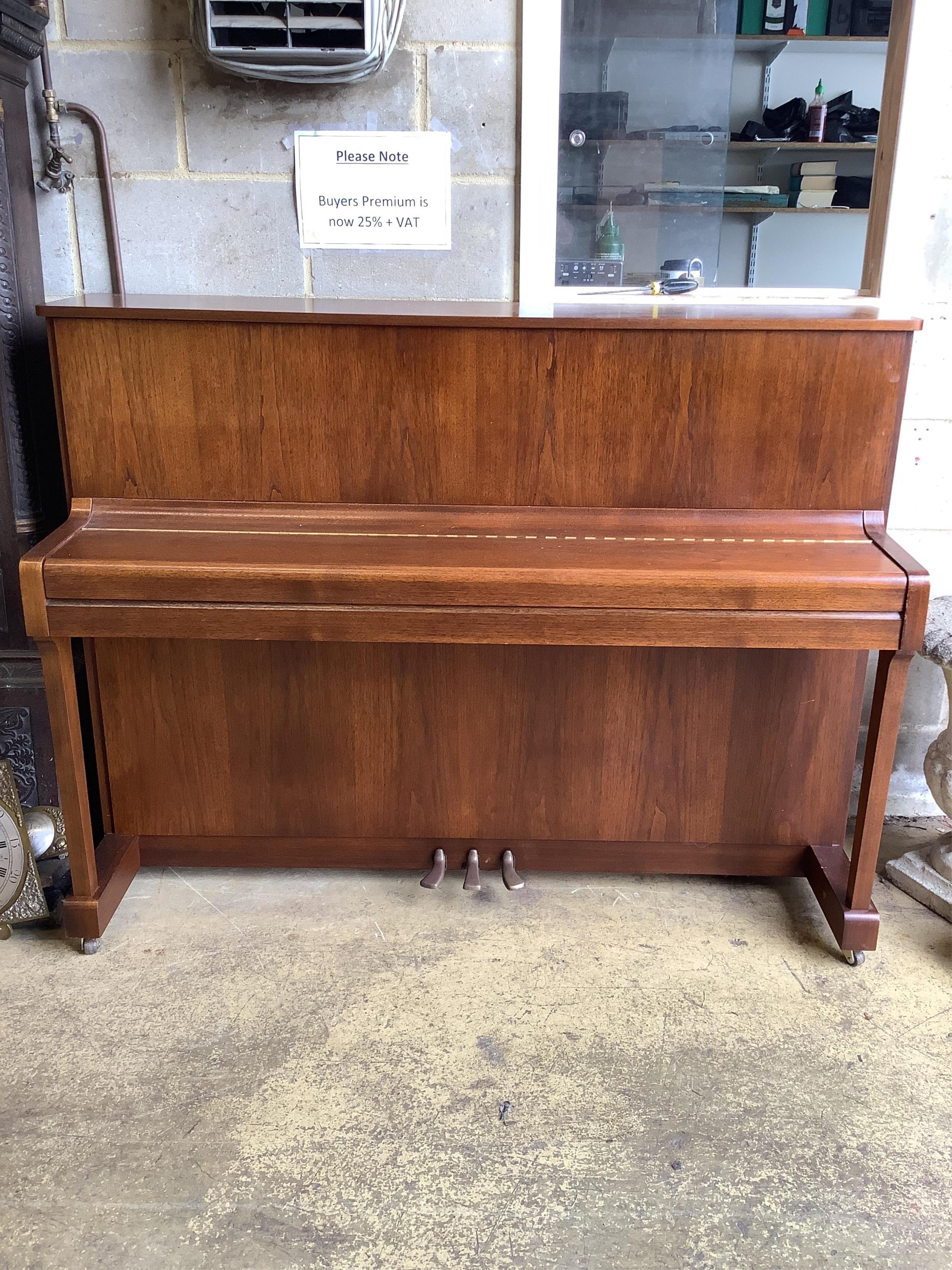 A Yamaha upright piano, model P116N, serial no.E252968, with its original sales booklet and an adjustable piano stool. Condition - good, in very good lightly used condition